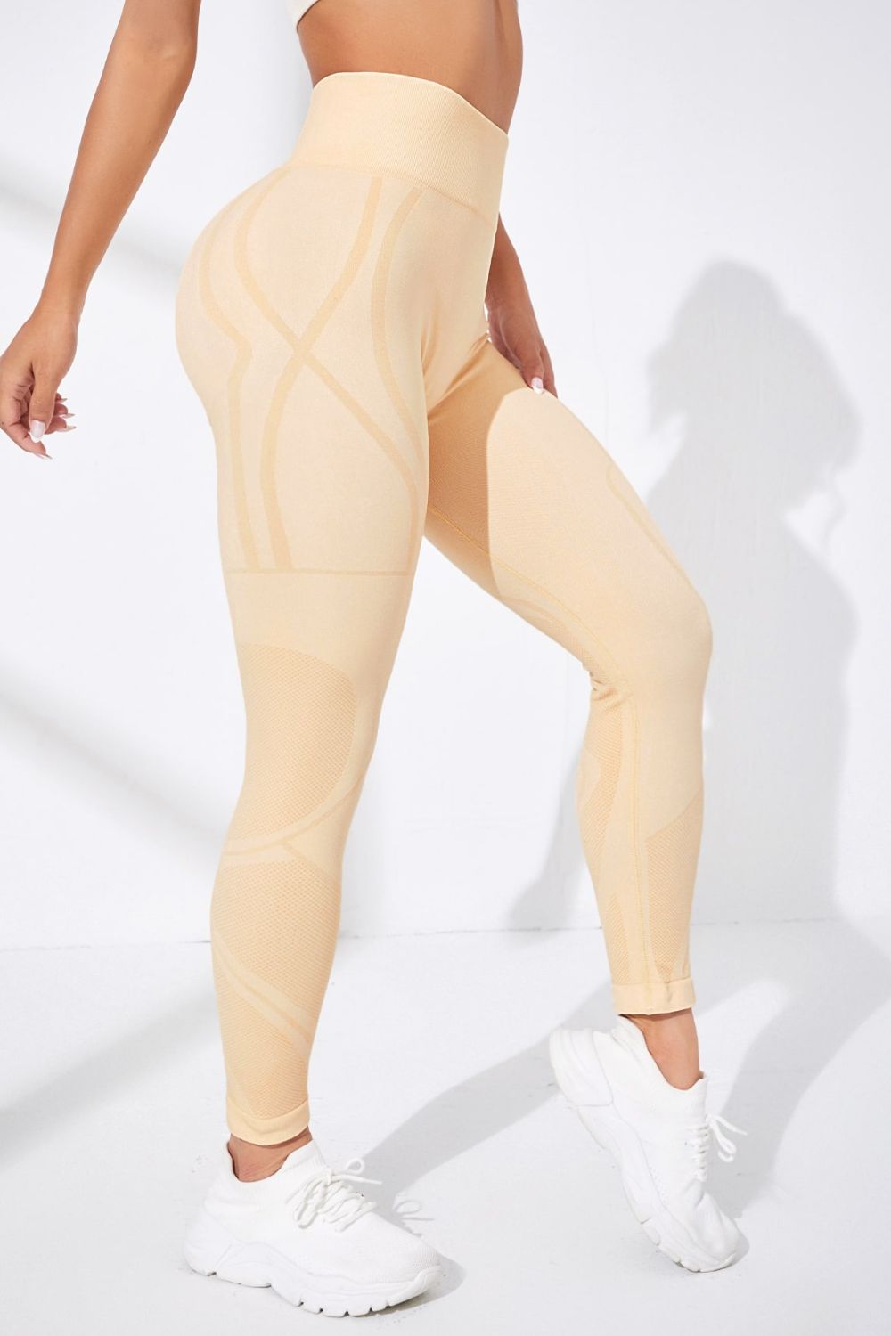 Beige leggings worn by a person on a white background