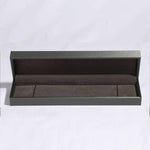 Open gray jewelry box on a white background