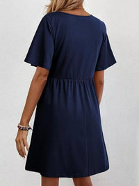 Navy blue dress worn by a person on a white background