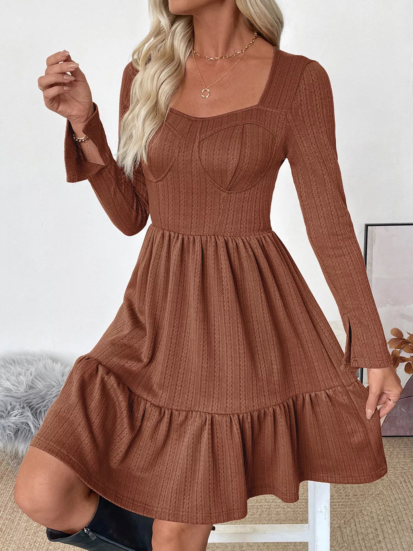Brown ribbed dress with long sleeves worn by a person indoors.