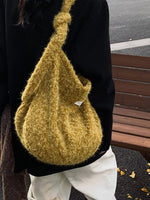 Person wearing a textured mustard yellow bag with a blurred background
