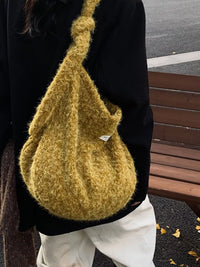 Person wearing a textured mustard yellow bag with a blurred background