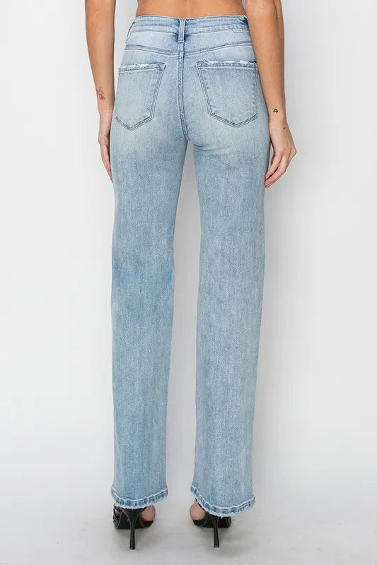 Light blue jeans worn by a person on a white background
