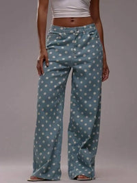 Person wearing blue polka dot pants on a plain background