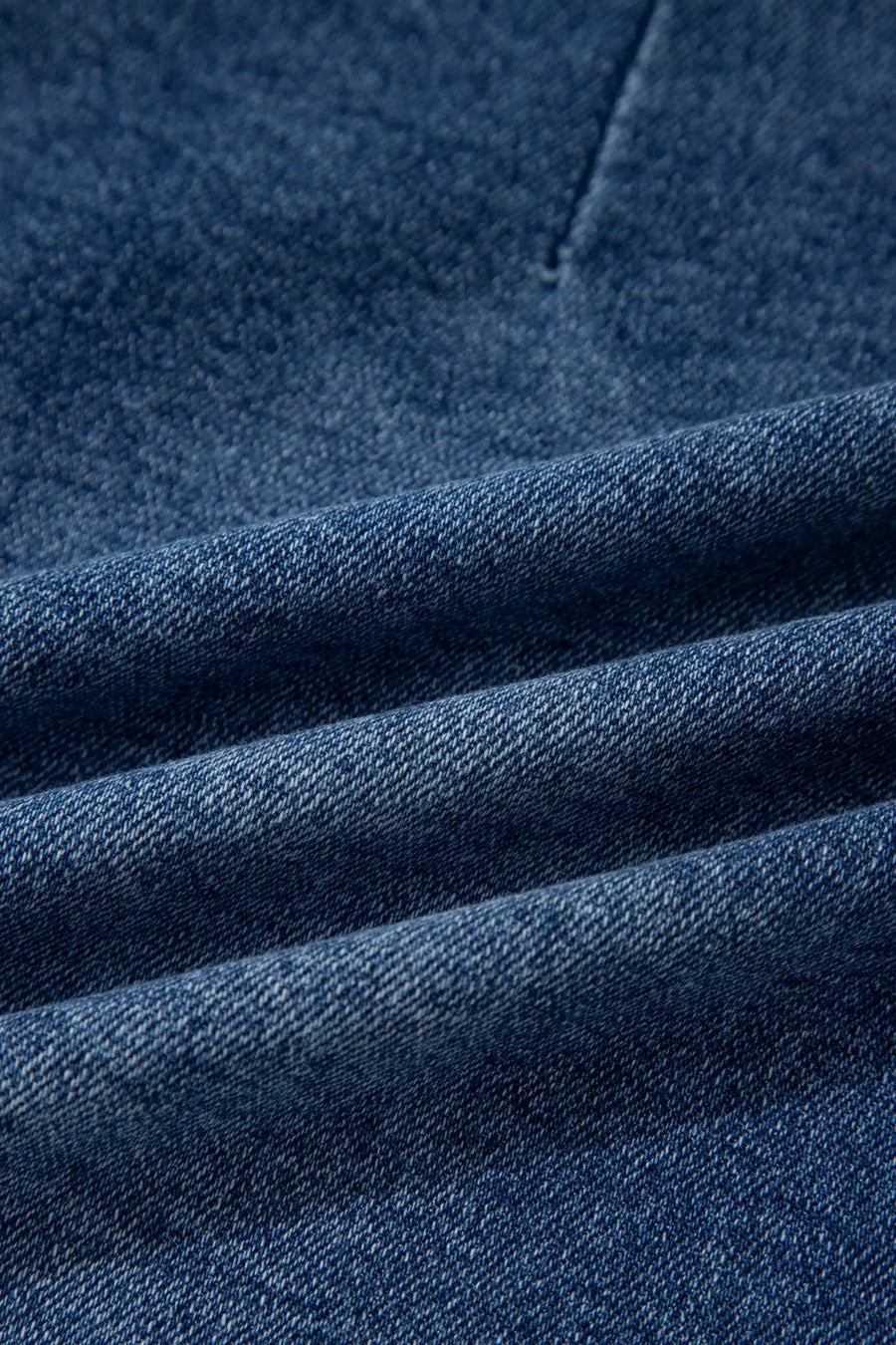 Close-up of blue denim fabric with visible texture