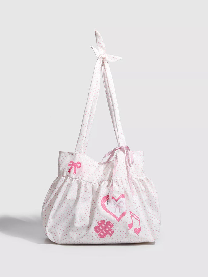 White drawstring bag with pink floral and musical note designs on a light gray background