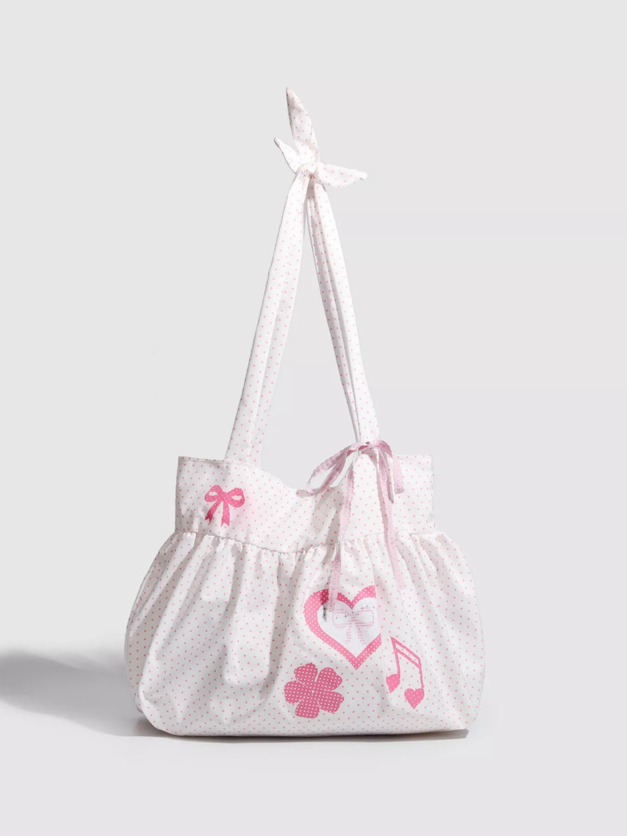 White drawstring bag with pink floral and musical note designs on a light gray background
