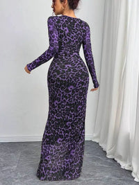 Woman wearing a purple leopard print dress against a white curtain background