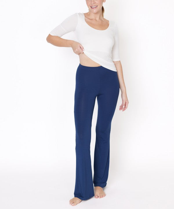 Woman wearing a white top and blue pants on a white background