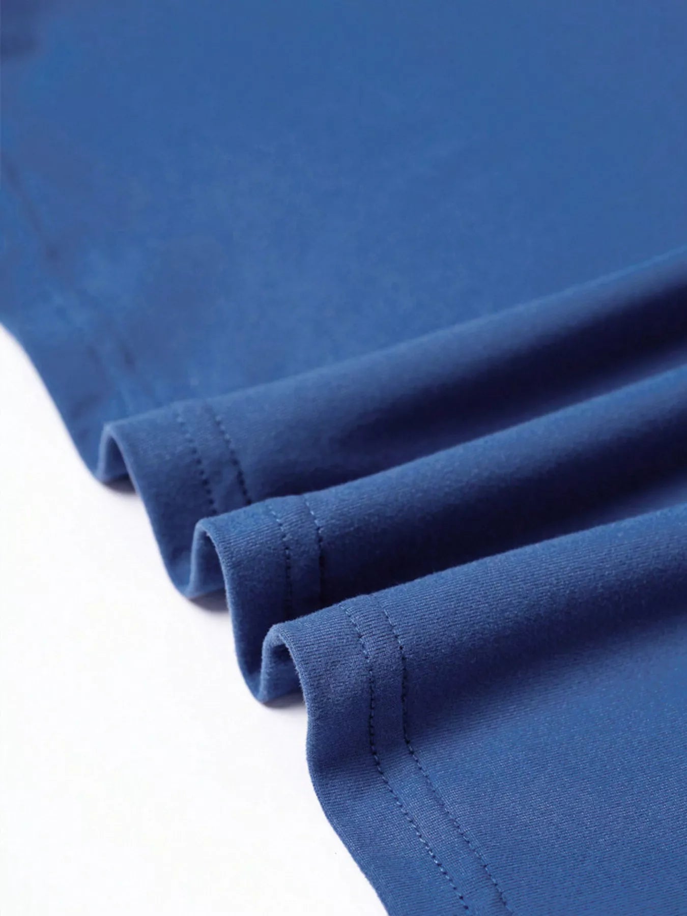 Close-up of blue fabric with a white background