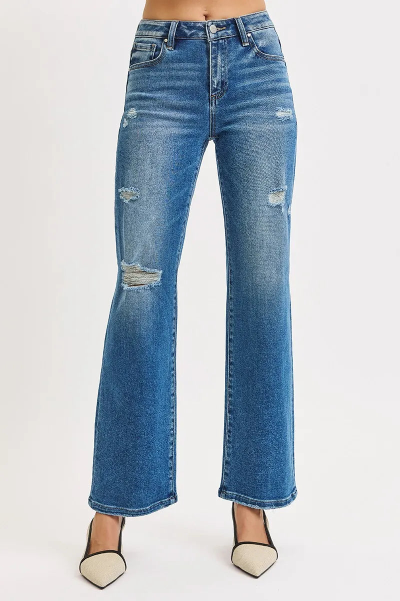 Blue jeans with slight distressing on a white background