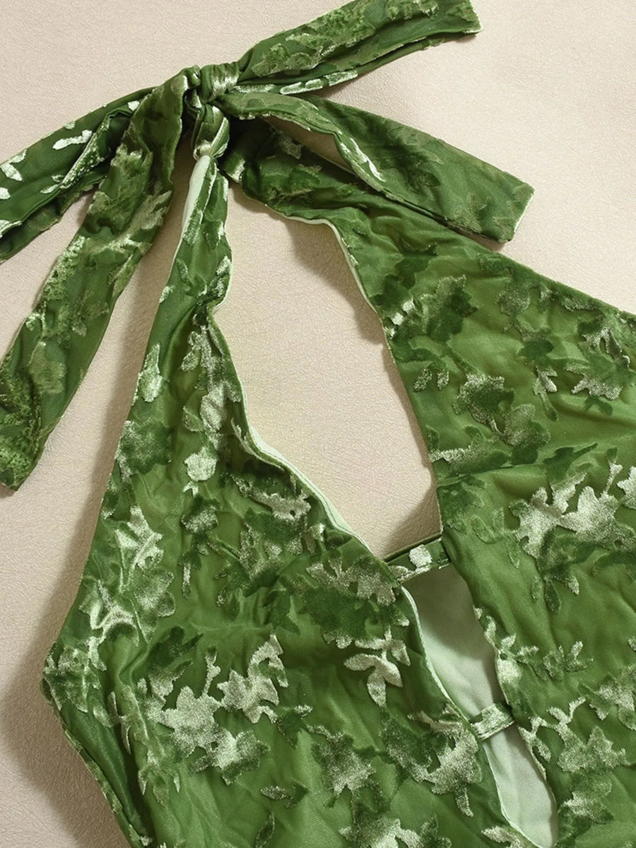 Green floral patterned top with a bow detail on a beige background