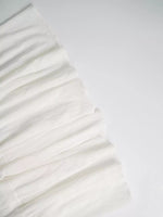 White fabric with ruffled texture on a white background