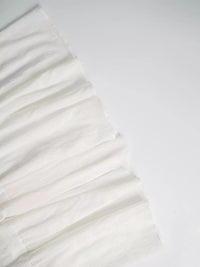 White fabric with ruffled texture on a white background