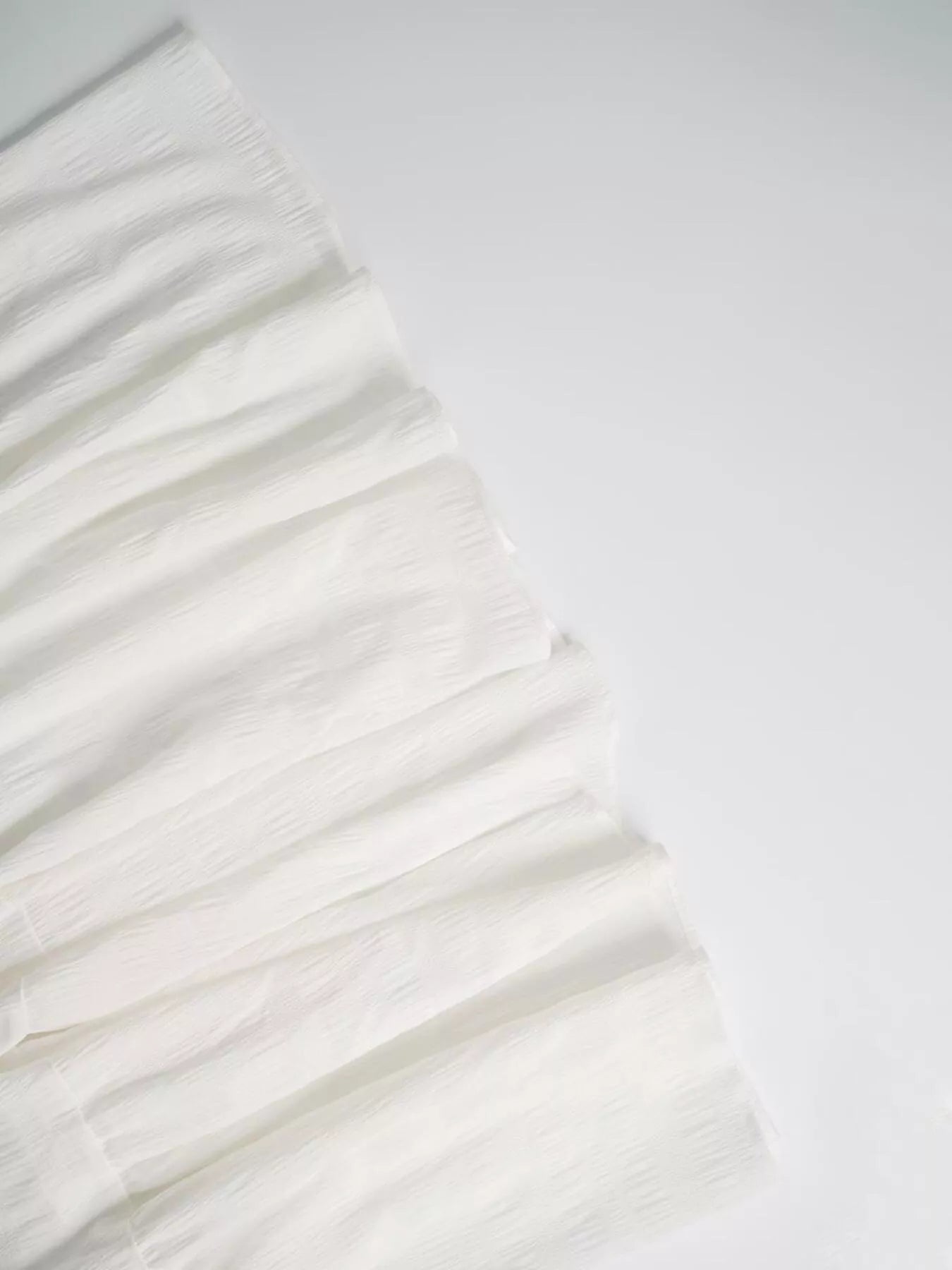 White fabric with ruffled texture on a white background