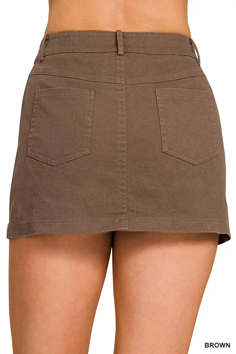 Brown skirt worn by a person on a white background