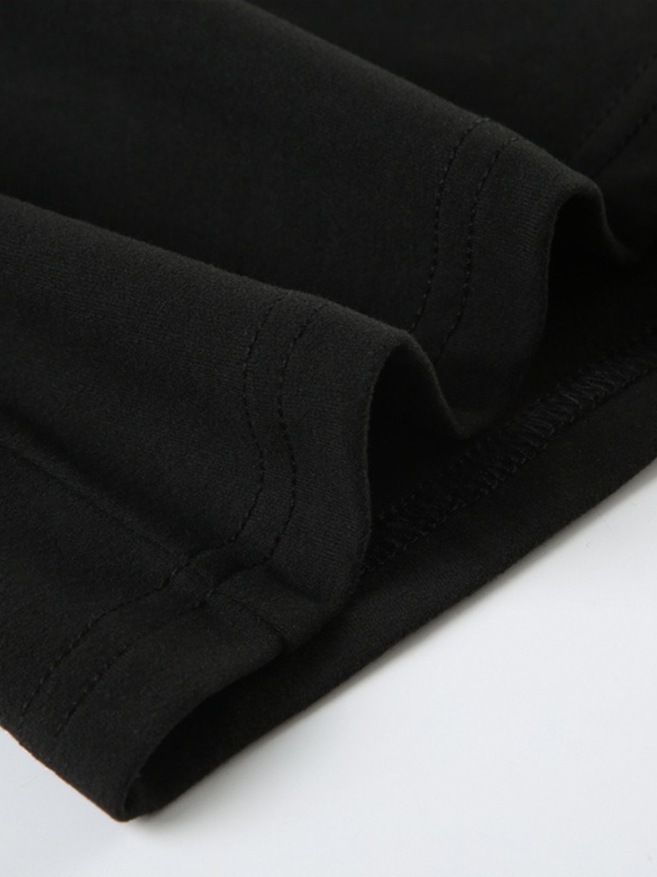 Close-up of a brown leather product with visible stitching on a white background