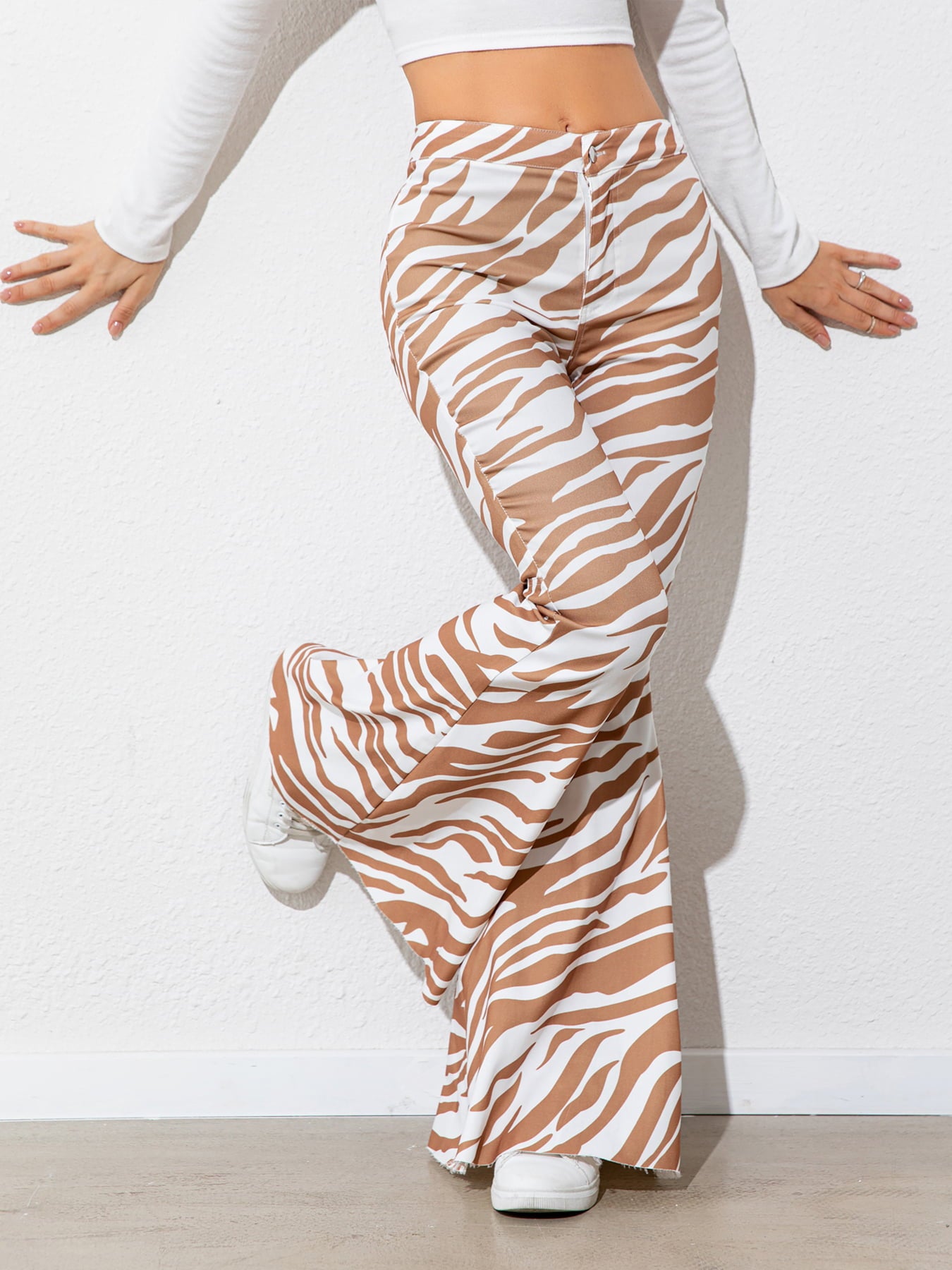 Person wearing zebra print pants on a white background