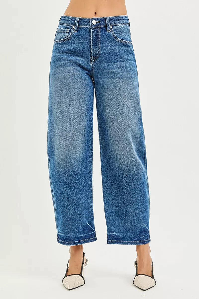 Blue jeans worn by a person on a light gray background