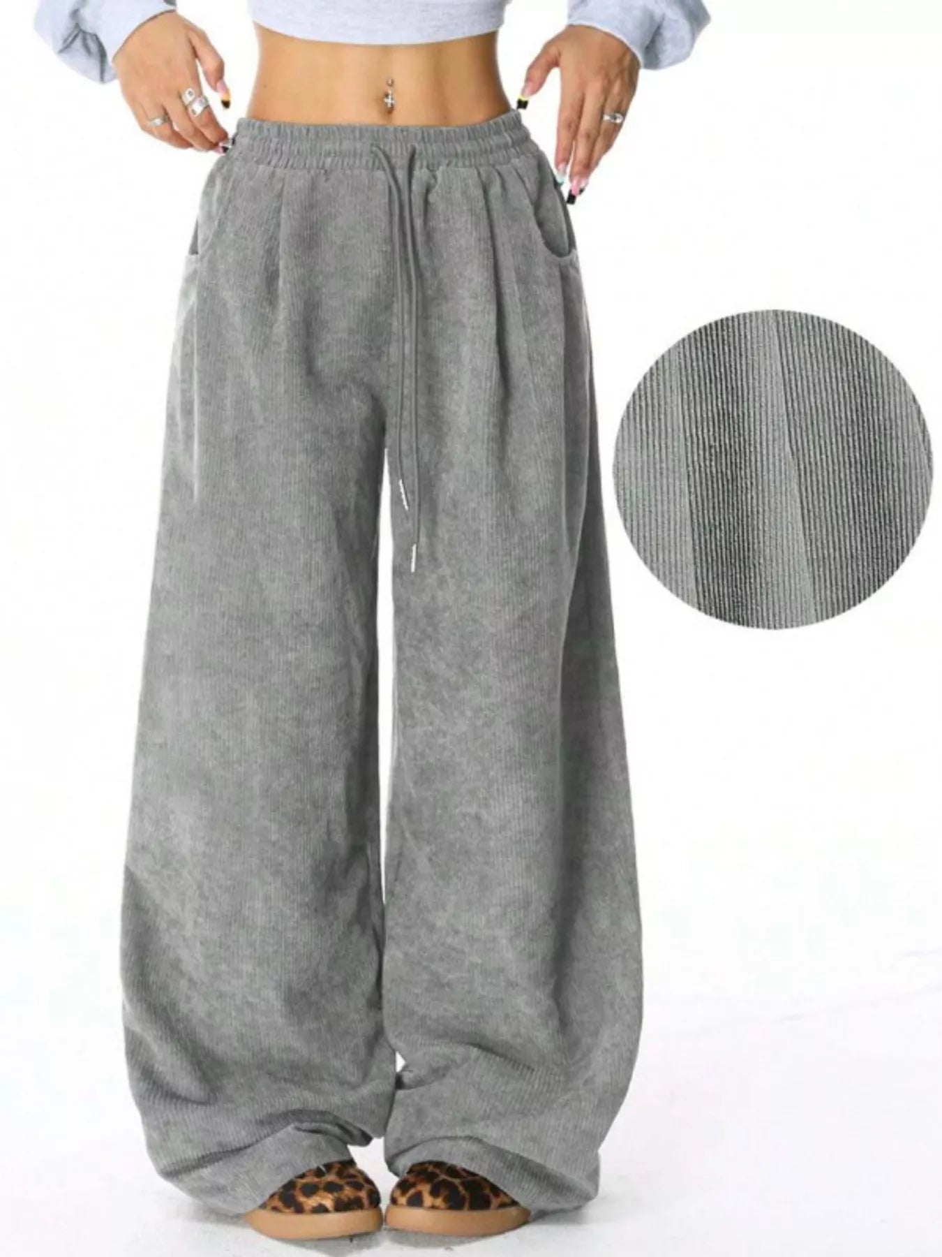 Gray wide-leg pants with a close-up of fabric texture on a white background