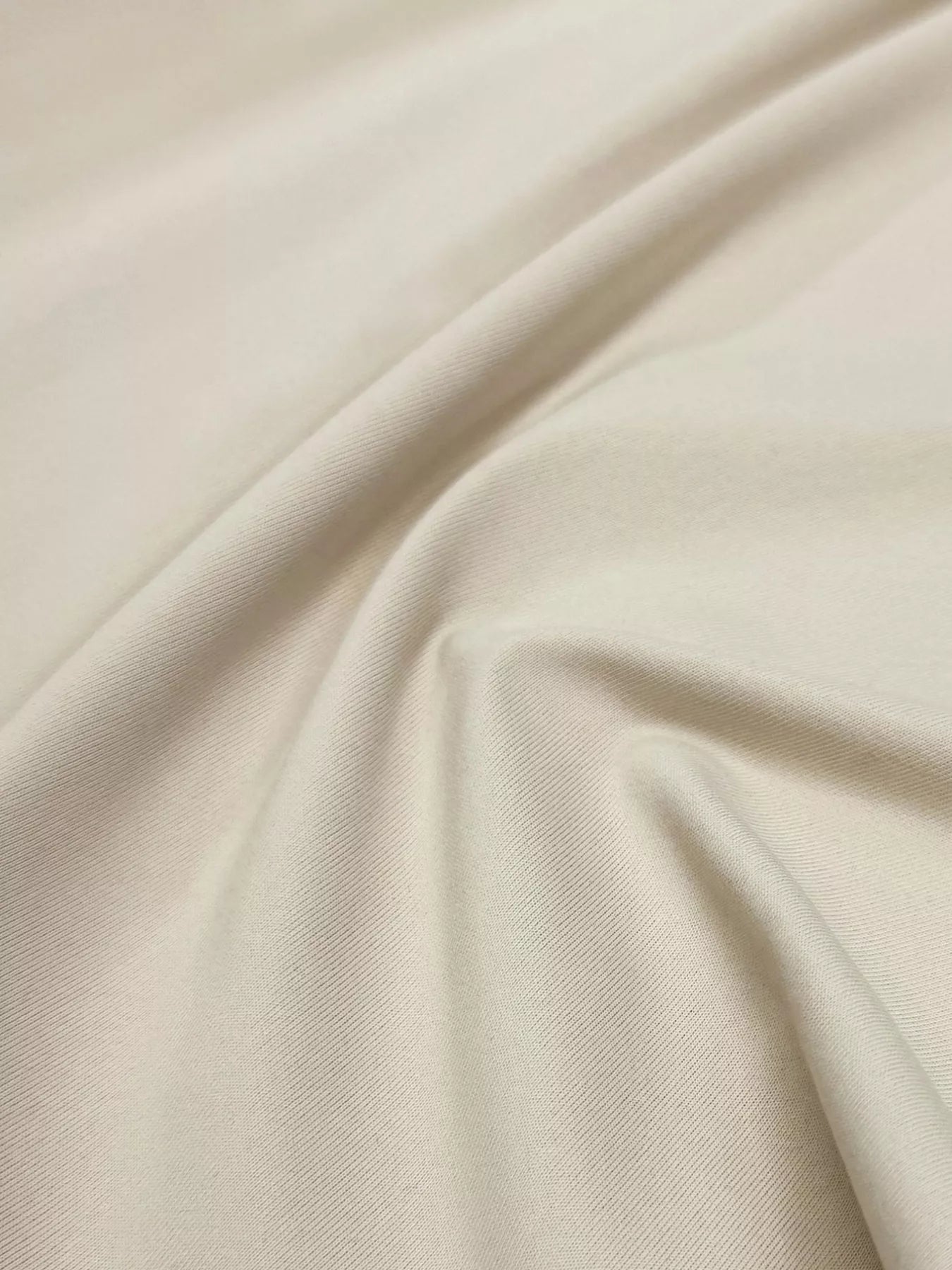 Close-up of beige fabric with folds