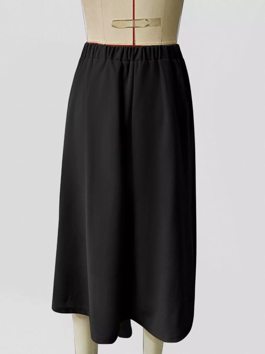 Black skirt on a mannequin against a white background