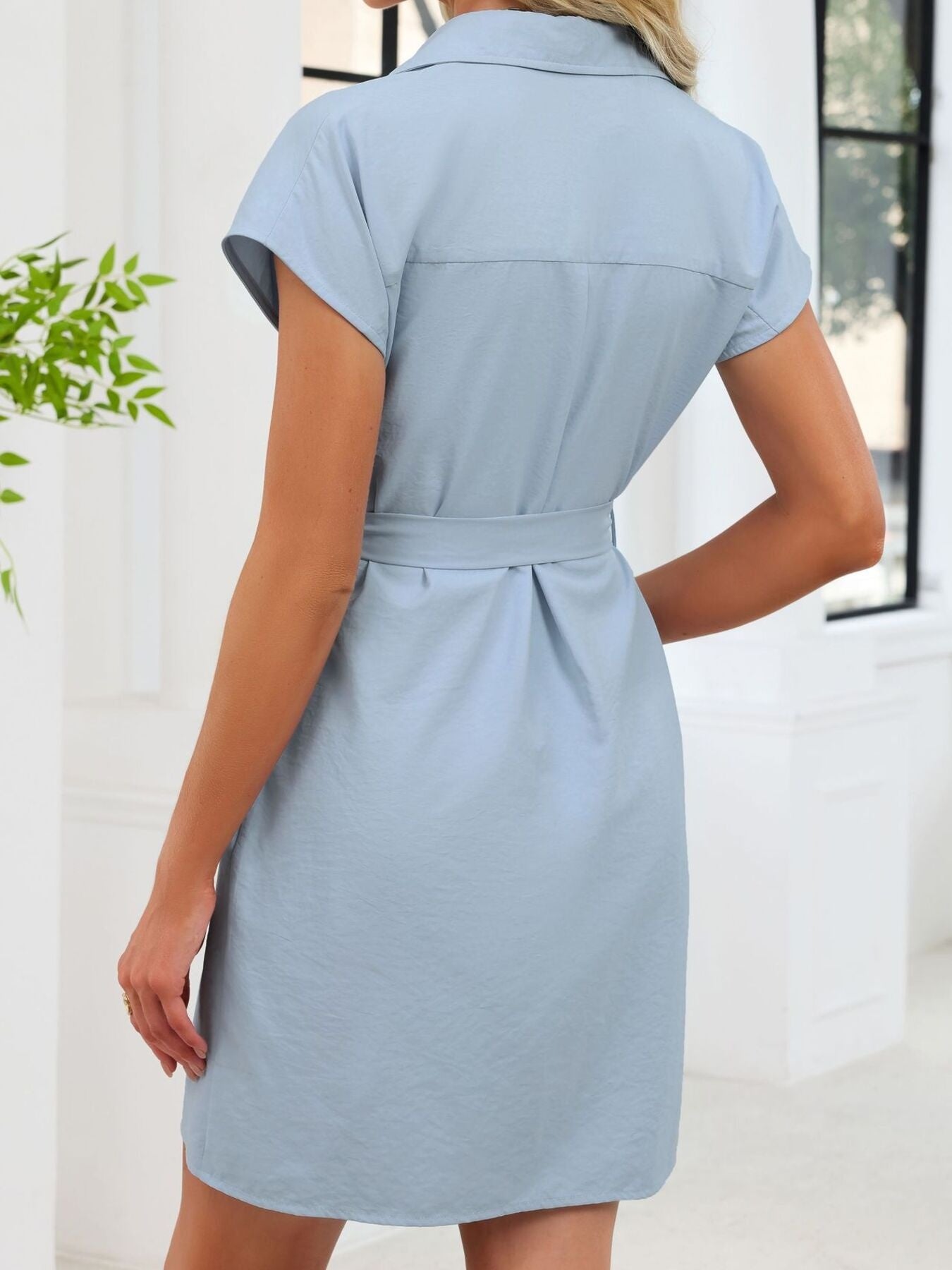 Light blue dress worn by a person with a white background