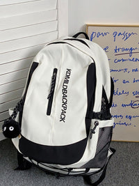 White backpack with black accents on a gray floor against a white wall.