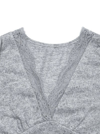 Gray sweater with lace trim on a white background