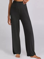 Black ribbed wide-leg pants worn by a person on a white background