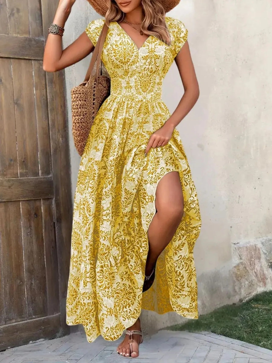 Woman wearing a yellow lace dress with a wooden door and stone wall in the background