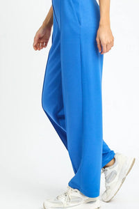 Blue pants worn by a person on a white background