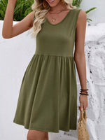 Woman wearing an olive green dress with a snowy background