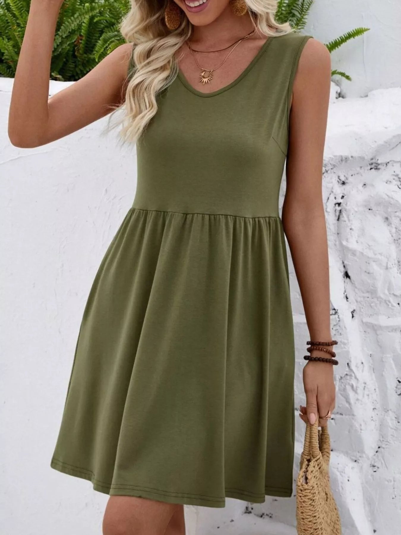 Woman wearing an olive green dress with a snowy background