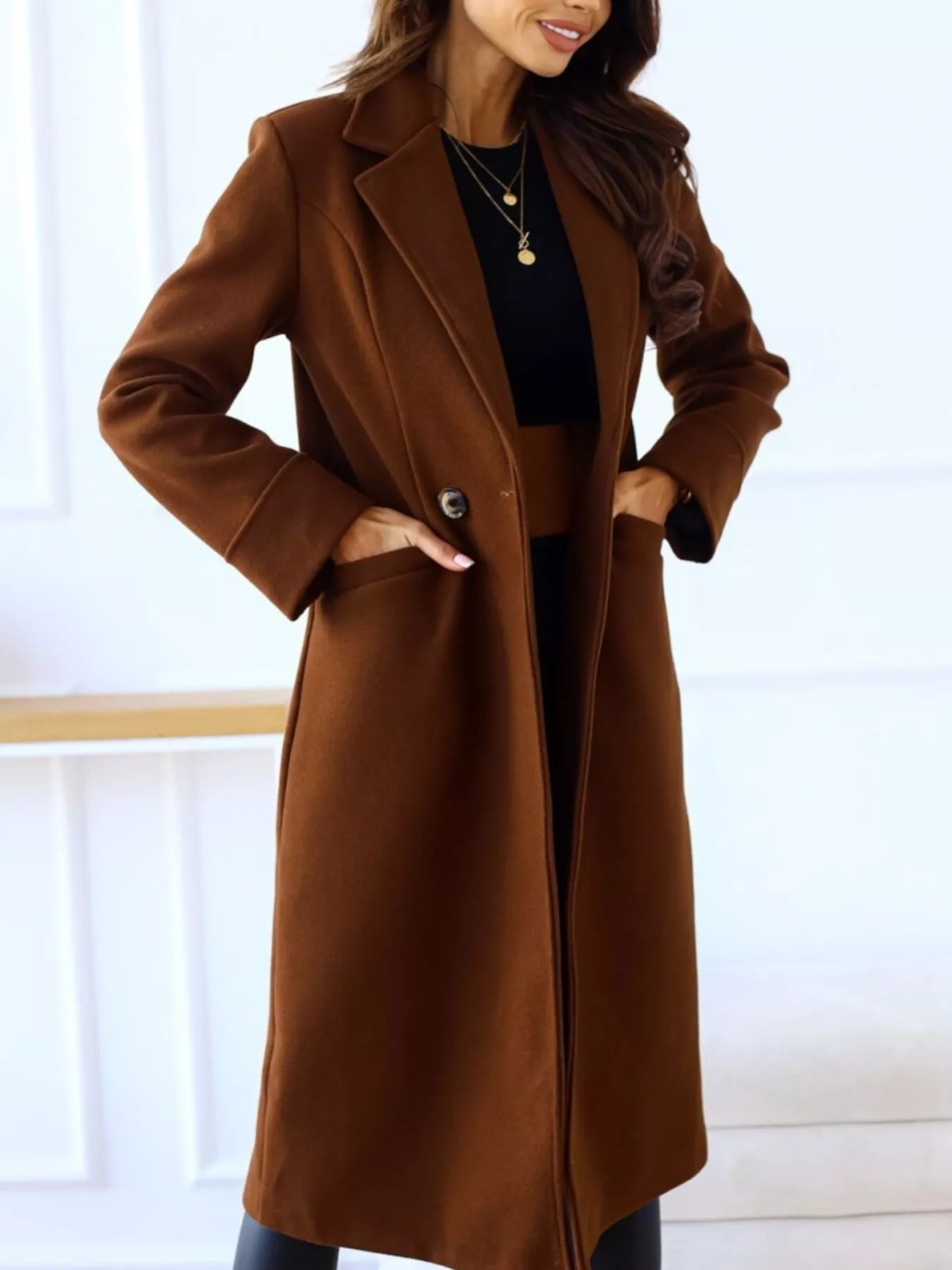Person wearing a brown coat with a white background