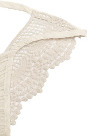 Close-up of a beige lace trim on a white background