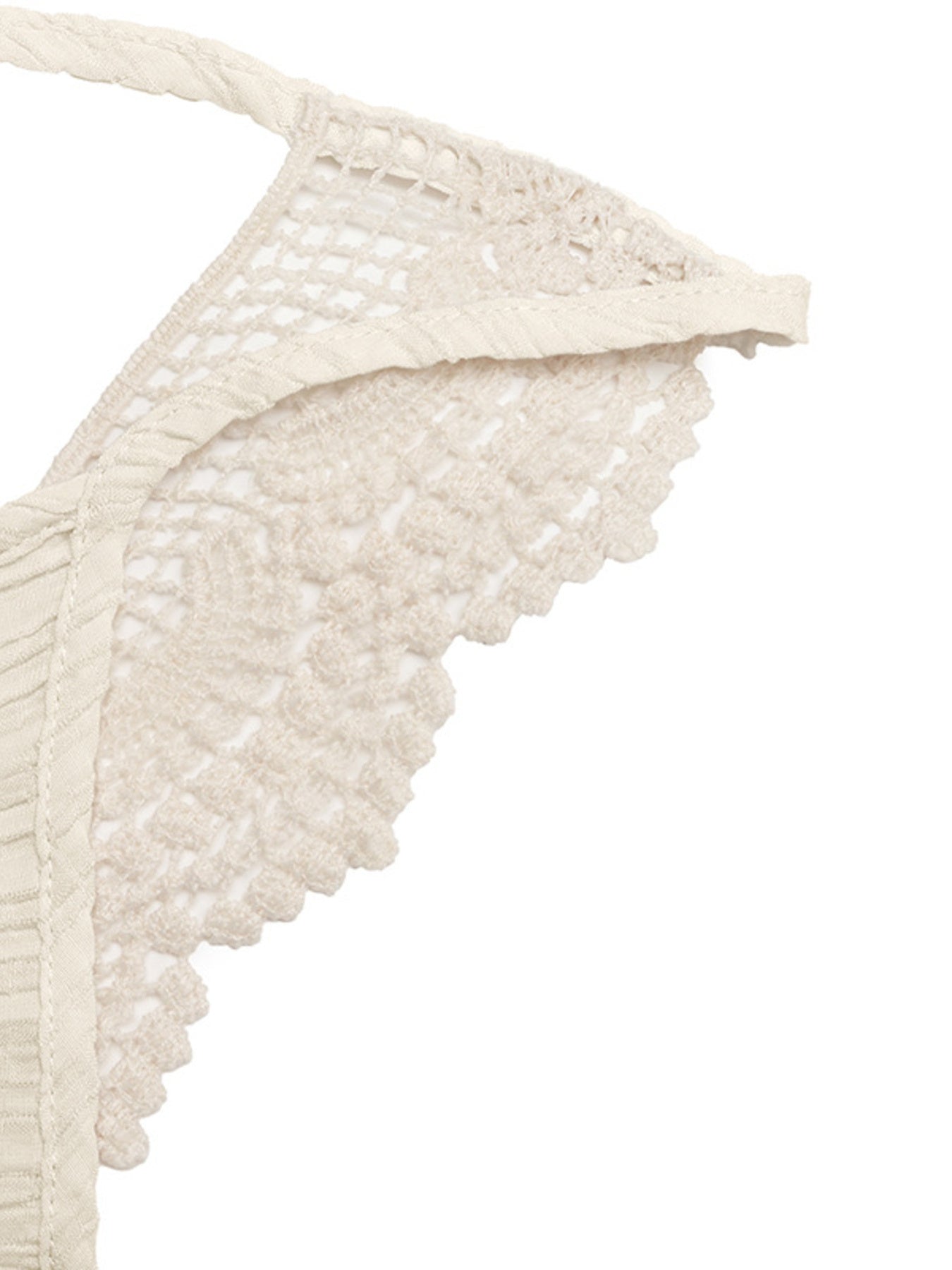 Close-up of a beige lace trim on a white background