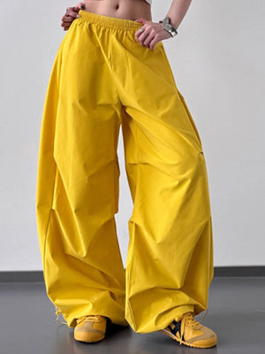 Yellow wide-leg pants worn by a person on a plain background