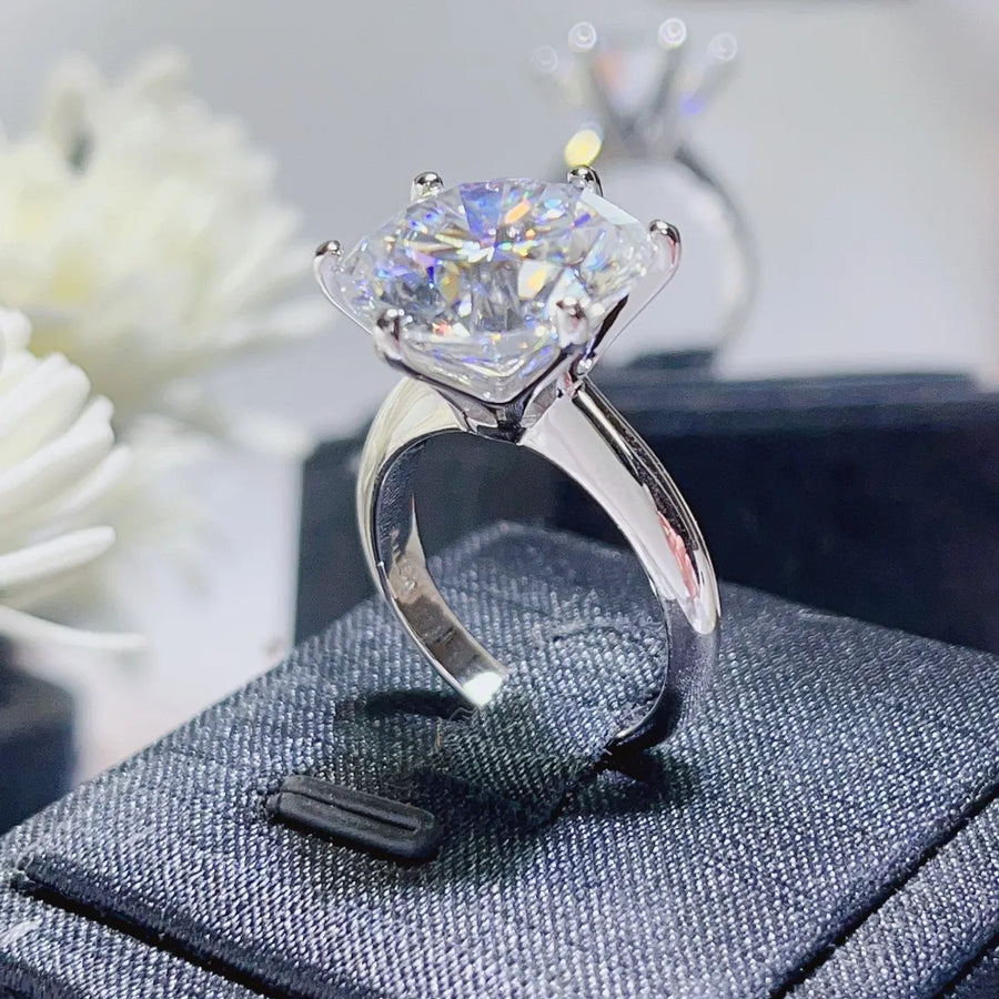 Silver ring with a large diamond on a textured surface