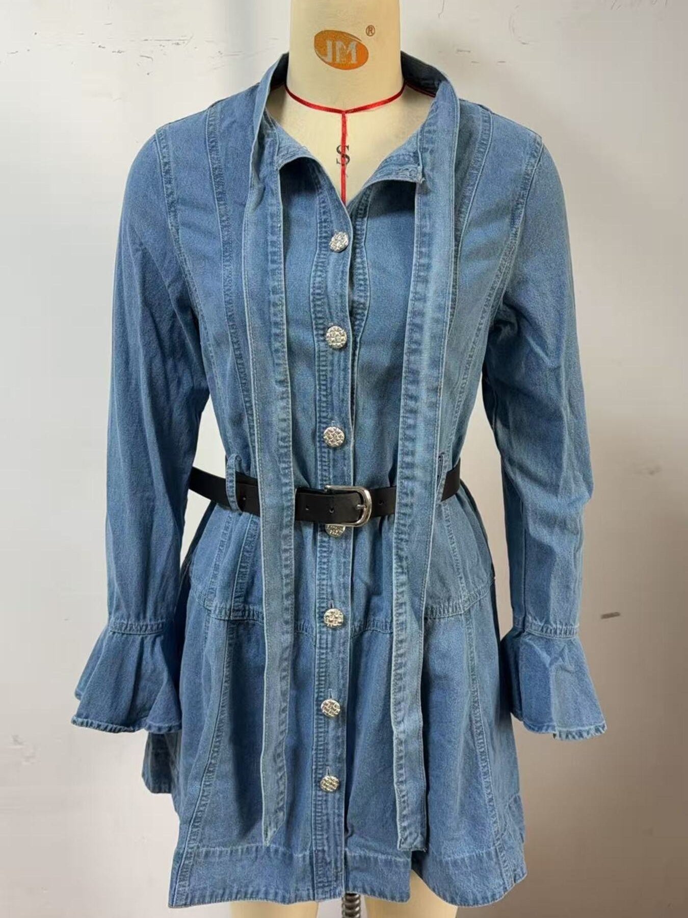 Blue denim dress on a mannequin against a plain background