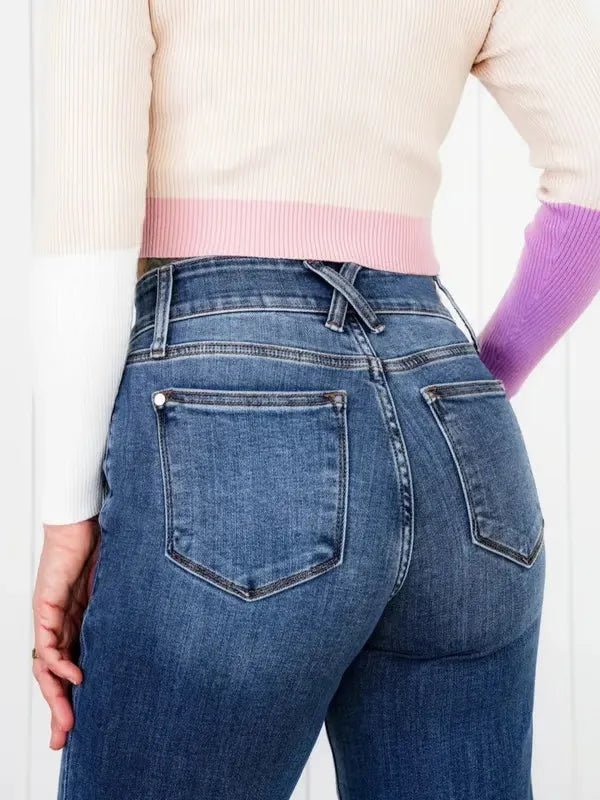 Person wearing blue jeans with a white background