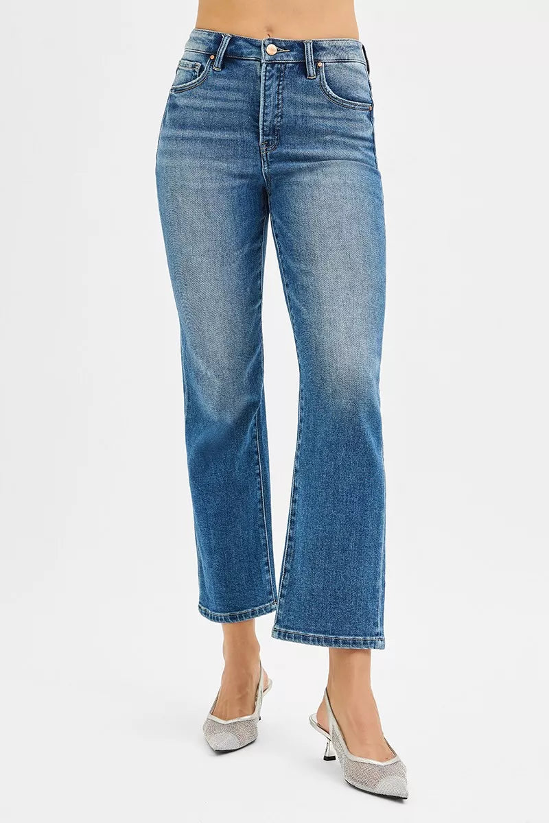 Blue jeans worn by a person on a white background