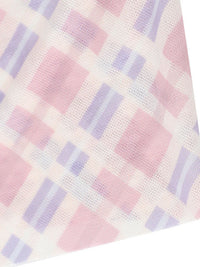 Close-up of a checkered fabric with pink and purple squares on a white background