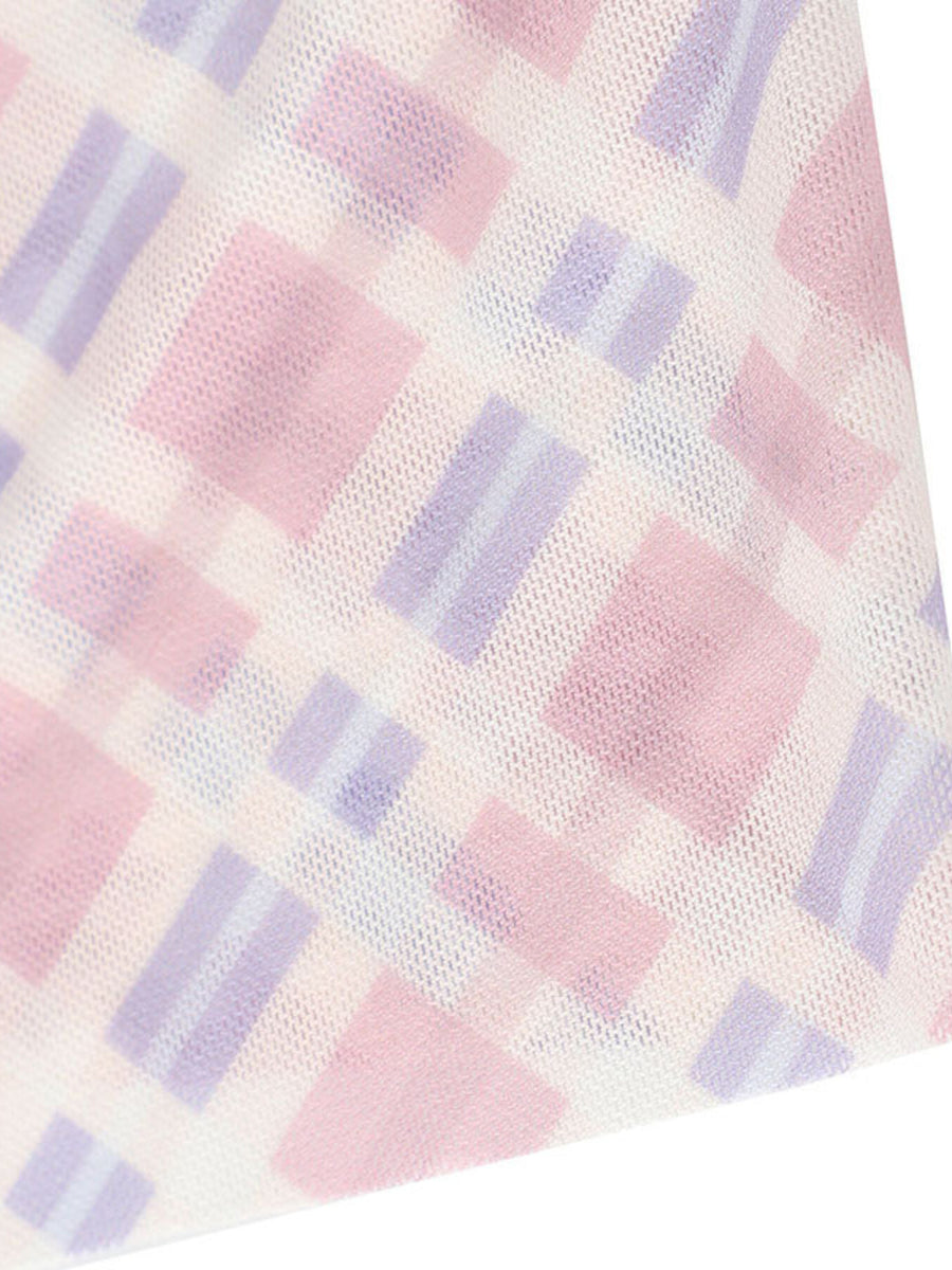 Close-up of a checkered fabric with pink and purple squares on a white background