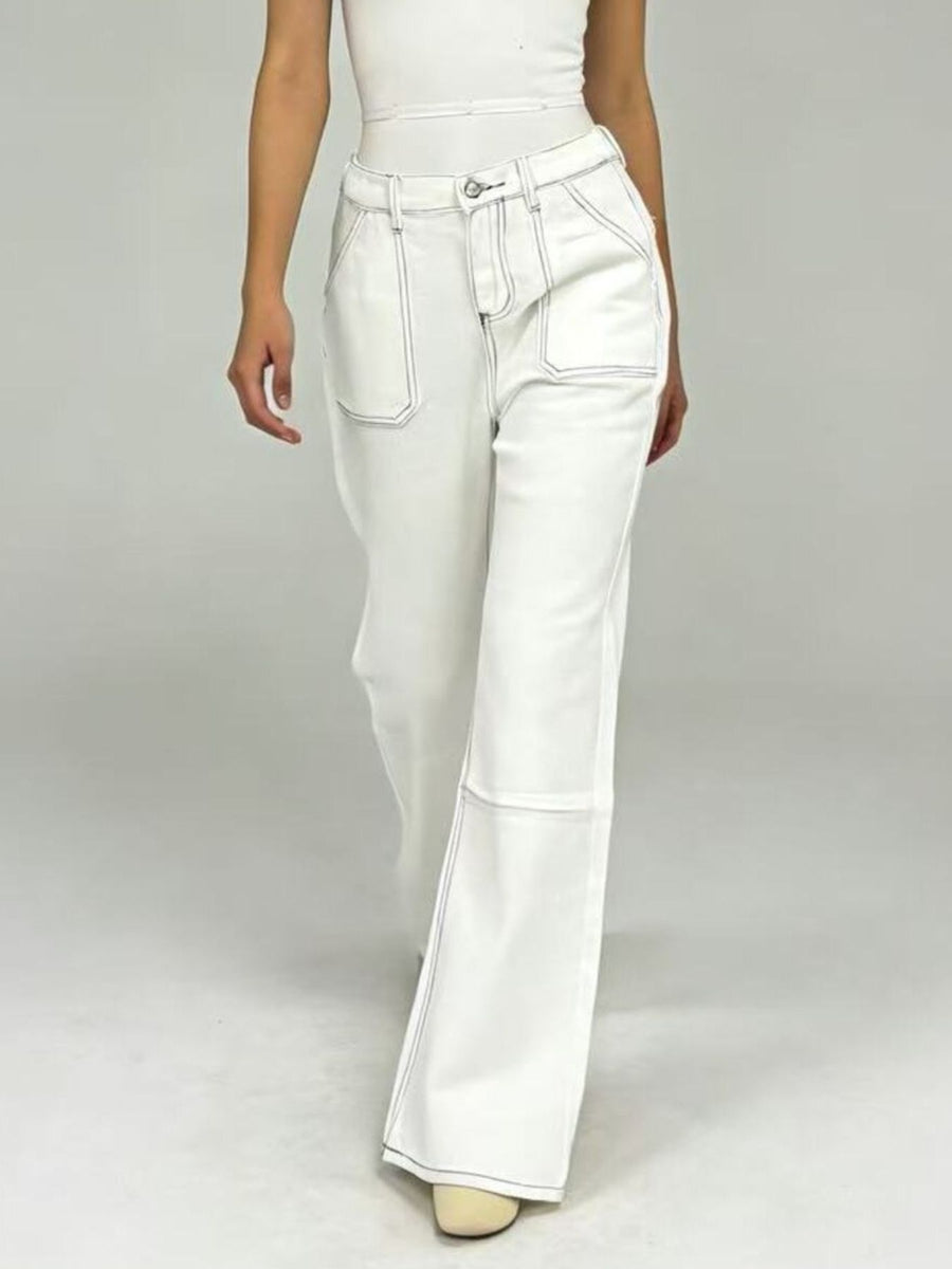 White pants worn by a person on a plain background