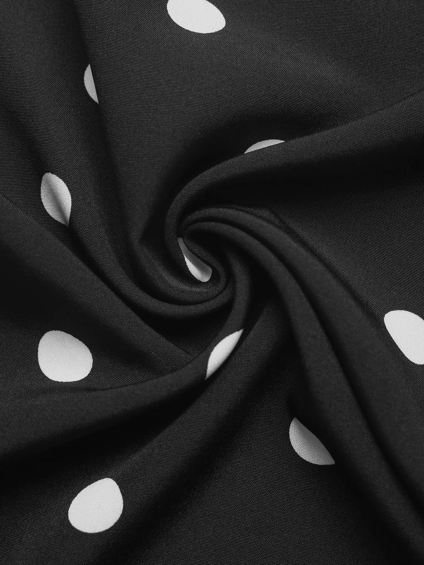 Black fabric with white polka dots