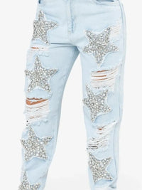 Light blue jeans with star-shaped embellishments on a white background