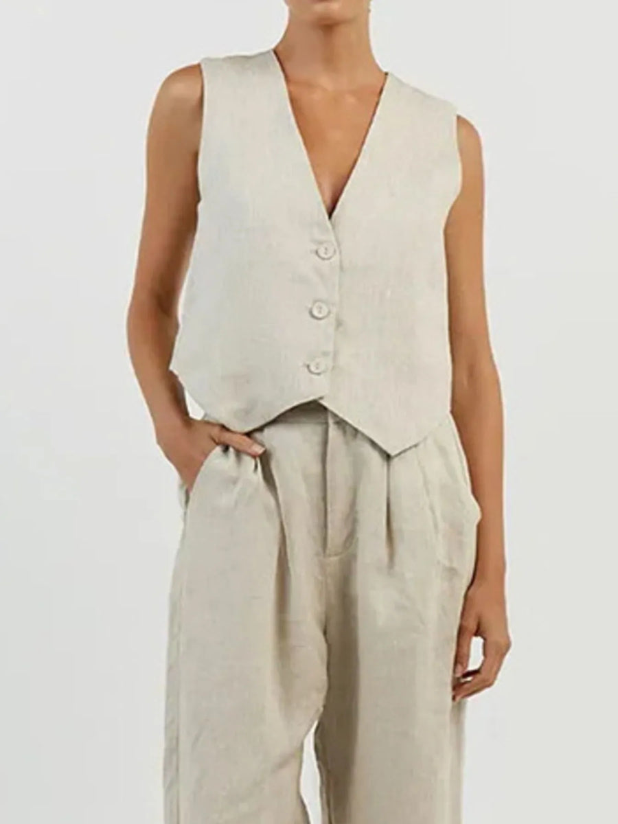 Person wearing a beige vest and pants on a plain background