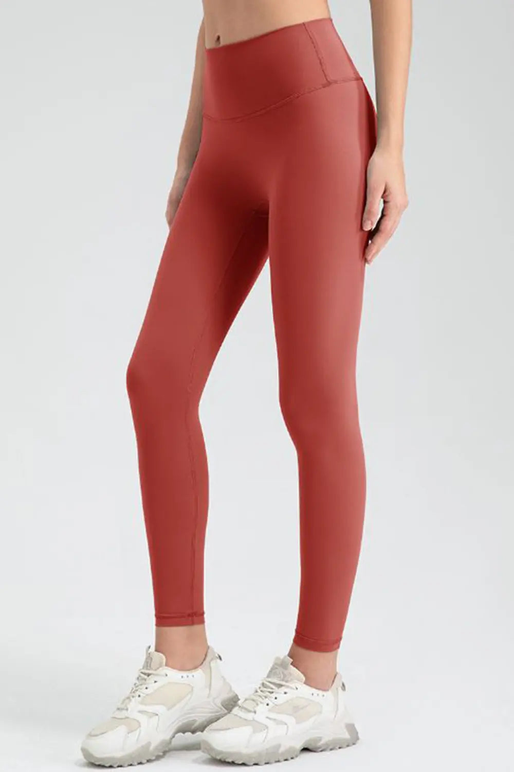 Red leggings worn by a person on a white background