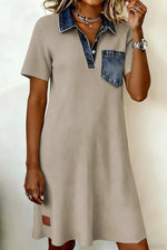 Beige dress with denim collar and pocket on a plain background